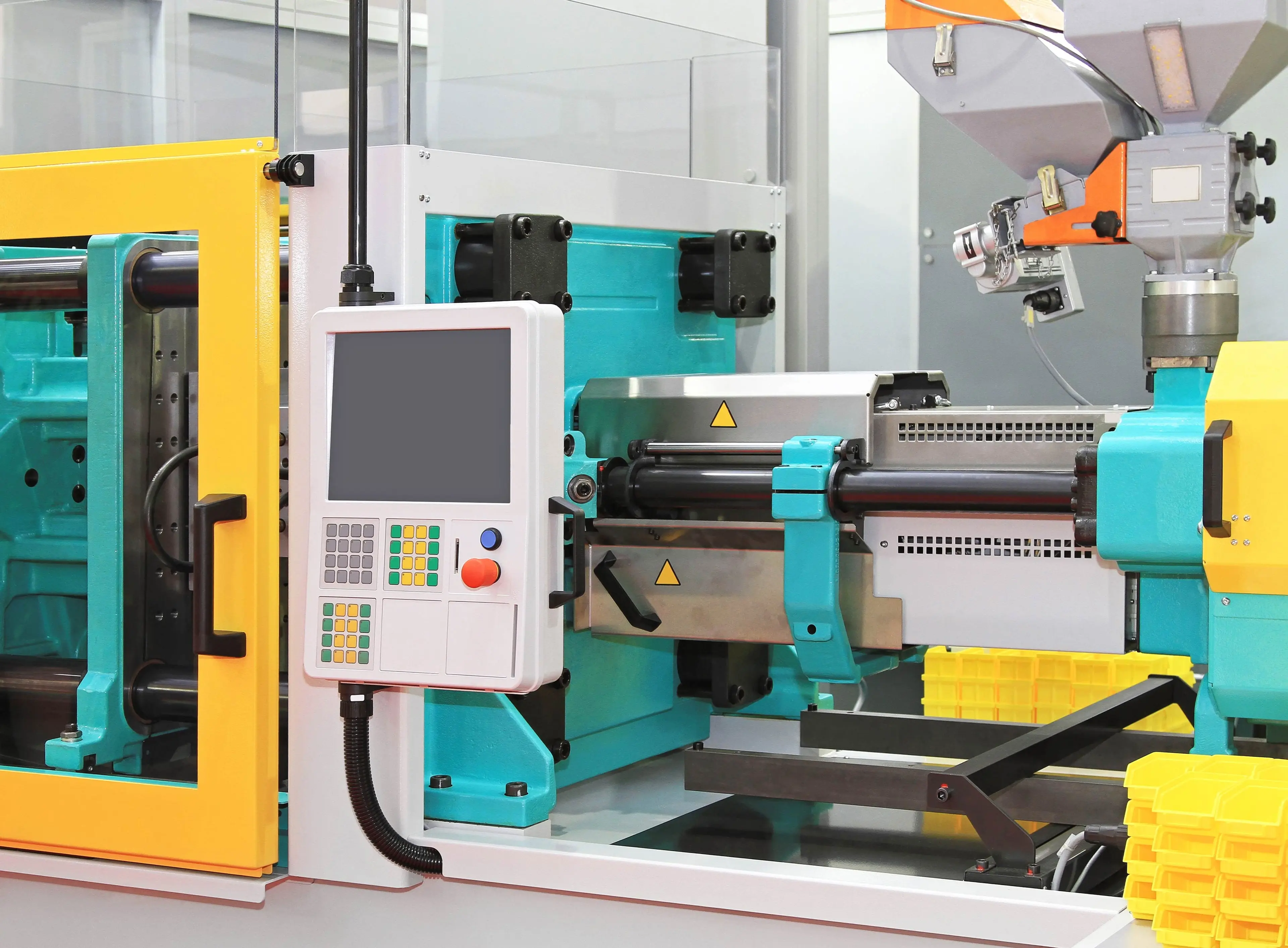 Injection molding machine: a device that uses high pressure to inject molten plastic into a mold for product formation.